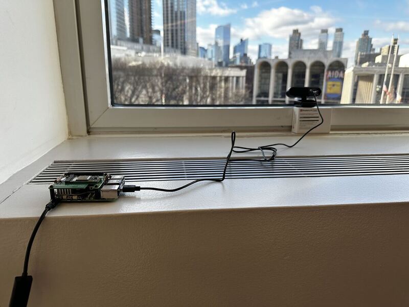 Raspberry Pi 5 with webcam pointed out a window